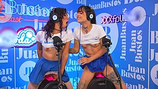 two hot lesbians straddle the sybian fuckmachine, grinding to explosive orgasms while juan bustos interviews their wild ride