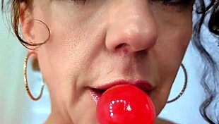 brunette bimbo licks sloppy oral fetish on huge lollipop dildo with those lips