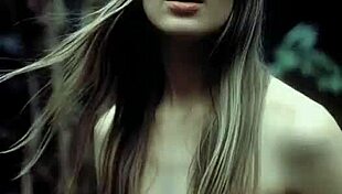 Wet beauty shows off perfect natural big tits topless posing in forest rain