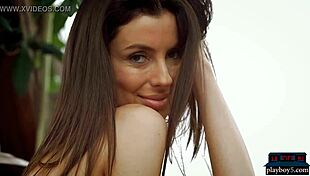 A busty brunette milf undresses slowly revealing huge softcore tits