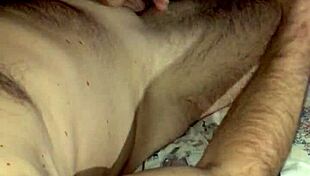 She jerks huge cock to cum explosion swapping loads in bedroom.