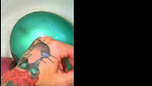 Tattooed girl teases balloons in steamy bath play