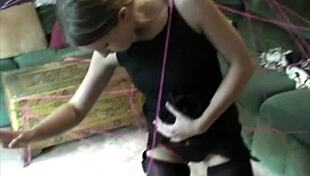 A young brunette teen strips pantyhose for toy play.