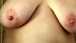 Chubby milf mama soaps up those big natural tits in shower