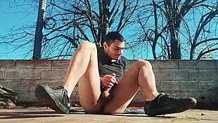 Muscular stud strokes monster cock outdoors to massive cumshot