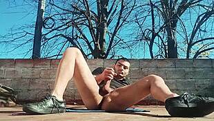 Muscular stud strokes monster cock outdoors to massive cumshot