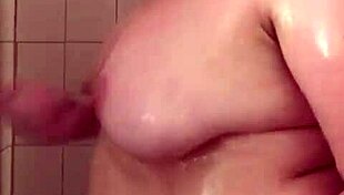 Chubby milf mama soaps up those big natural tits in shower