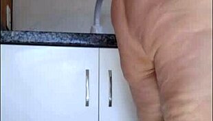 hidden cam catches stepmom's sheer panty tease in kitchen