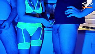 Neon lights glow as wife sucks two cocks in wild threesome
