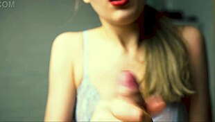 a beauty with red lips jerks off her boyfriend close-up pov