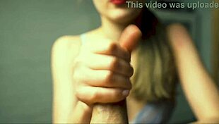 a beauty with red lips jerks off her boyfriend close-up pov