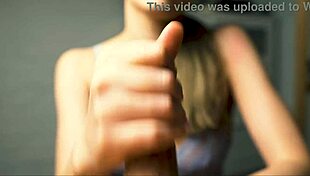 a beauty with red lips jerks off her boyfriend close-up pov