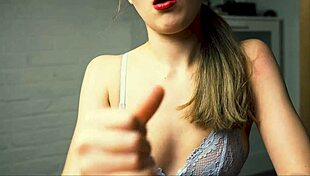 a beauty with red lips jerks off her boyfriend close-up pov