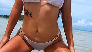 whoa, check out this tanned beauty shaking her sexy bikini body on the beach!