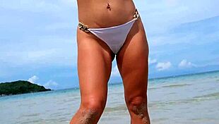 whoa, check out this tanned beauty shaking her sexy bikini body on the beach!