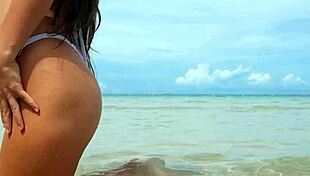 whoa, check out this tanned beauty shaking her sexy bikini body on the beach!