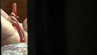 That peeping tom spots the hot amateur milf fingering her pussy wildly through the hotel window