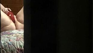 That peeping tom spots the hot amateur milf fingering her pussy wildly through the hotel window