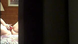 That peeping tom spots the hot amateur milf fingering her pussy wildly through the hotel window