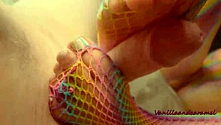 Sexy latina milf in fishnets gives kinky footjob while fingering wet pussy close-up