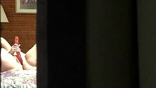 That peeping tom spots the hot amateur milf fingering her pussy wildly through the hotel window