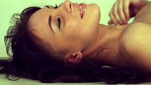 dark haired teen stands horny before mirror undressing her shaved body slowly