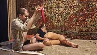 A guy gives a girl an enema at home