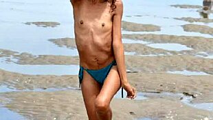 Nude model does public beach photoshoot with small tits